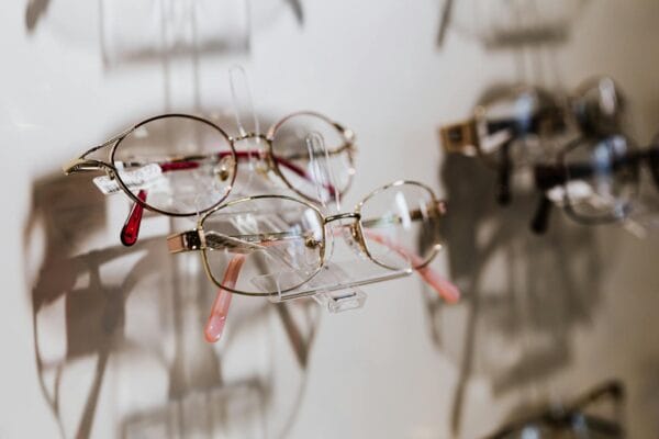 A close-up of stylish eyewear on display highlighting reflections and shadows.