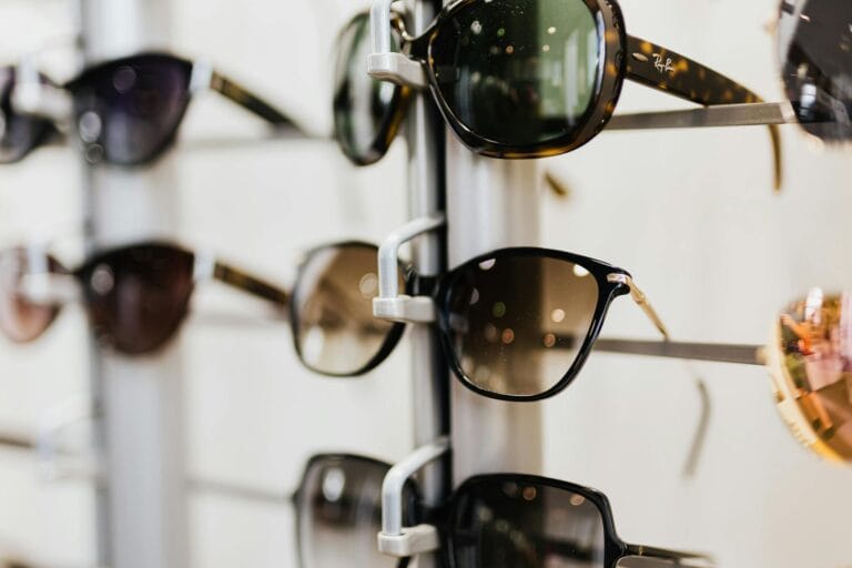 A selection of stylish sunglasses displayed on a retail stand. Ideal for eyewear fashion enthusiasts.