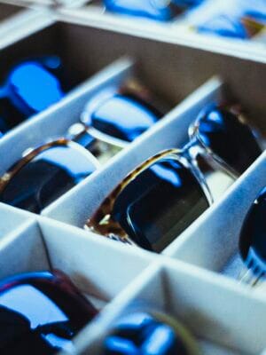 Close-up view of assorted sunglasses neatly arranged in display racks.